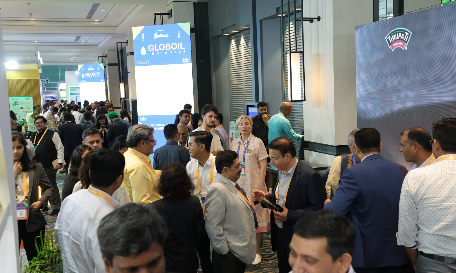 GLOBOIL India 2024 exhibition floor — busy delegate networking outside the Tirupati and Tefla's exhibitor stands